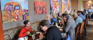 Bright artwork by Mylette Welch overlooks lunch patrons at Buckhorn Grill in midtown Sacramento'